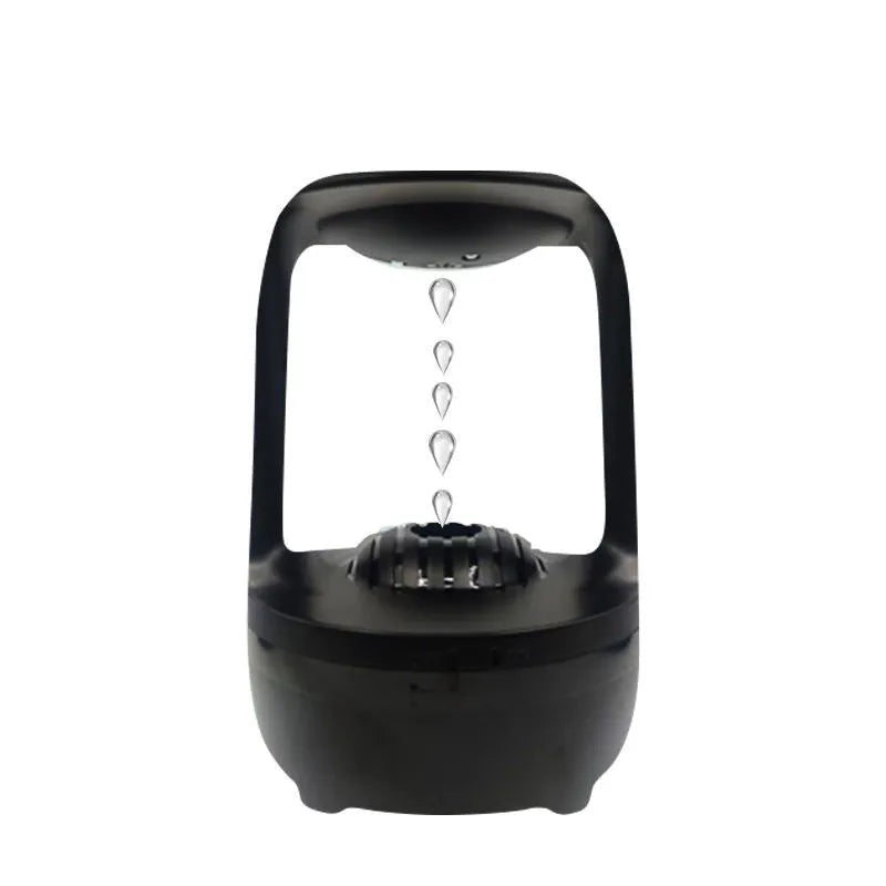 White anti-gravity humidifier showing floating water droplets on a desk next to a USB cable.
