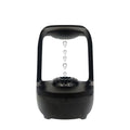 White anti-gravity humidifier showing floating water droplets on a desk next to a USB cable.