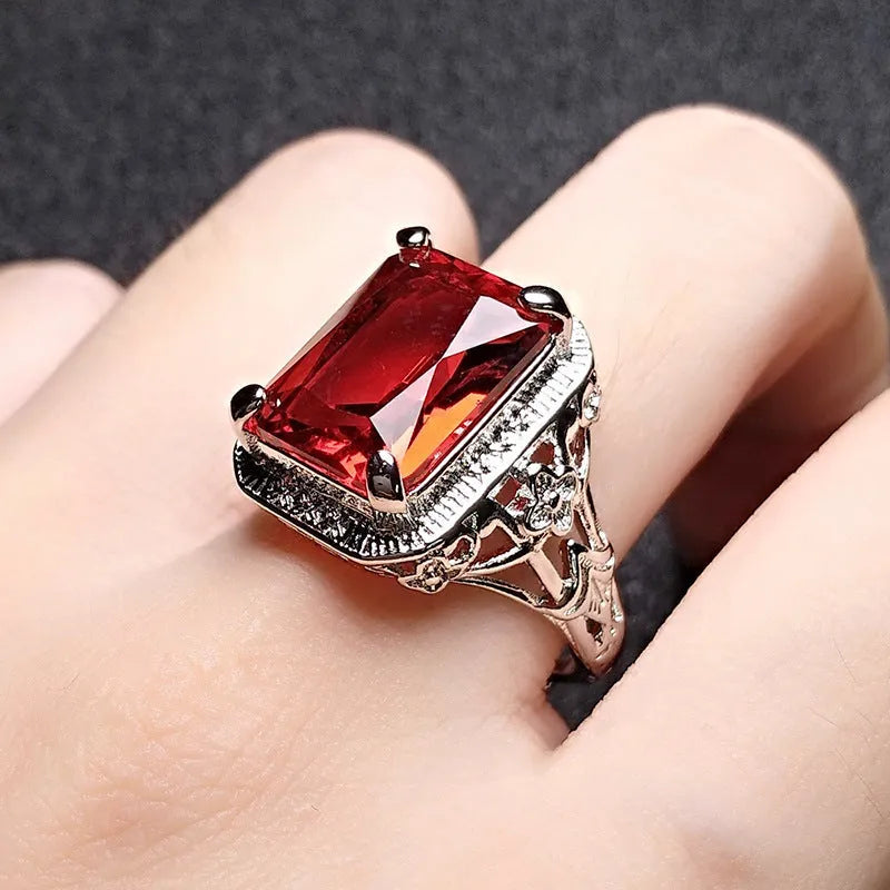 Women's adjustable geometric ring with electroplated copper construction and ruby styling