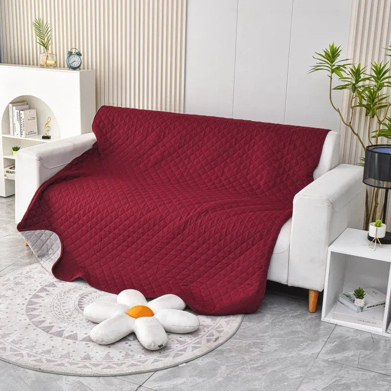 Reversible dog blanket sofa cover in grey and cream colours laid flat on a sofa