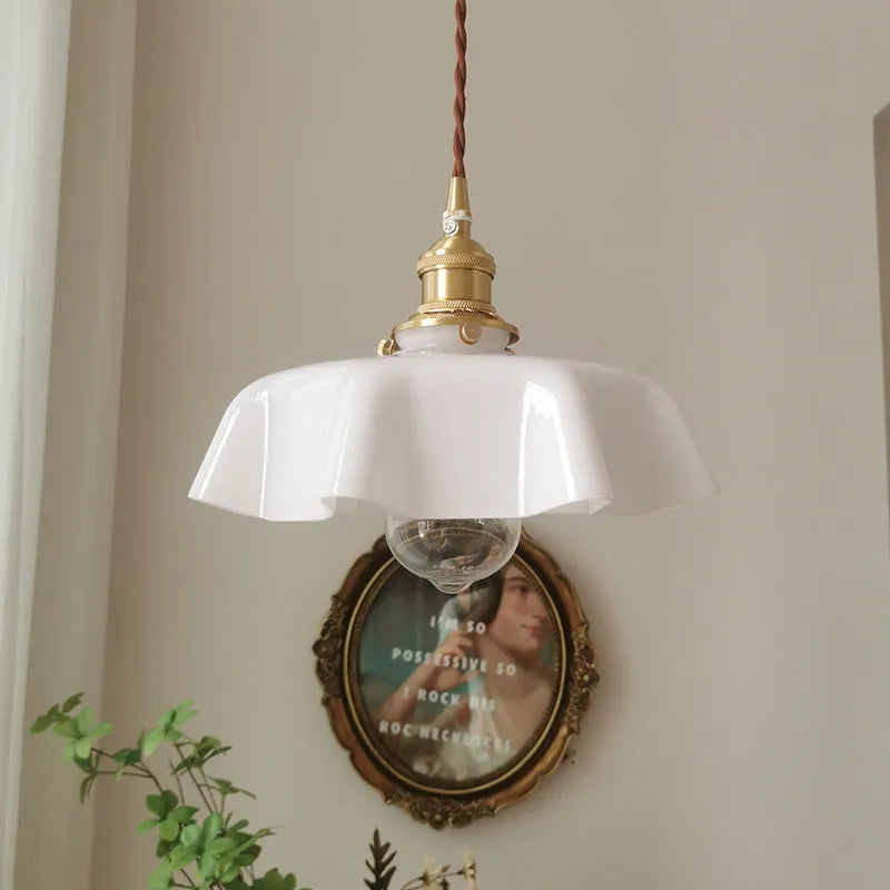 Medieval French style brass chandelier with flower bud details and glass lamp body