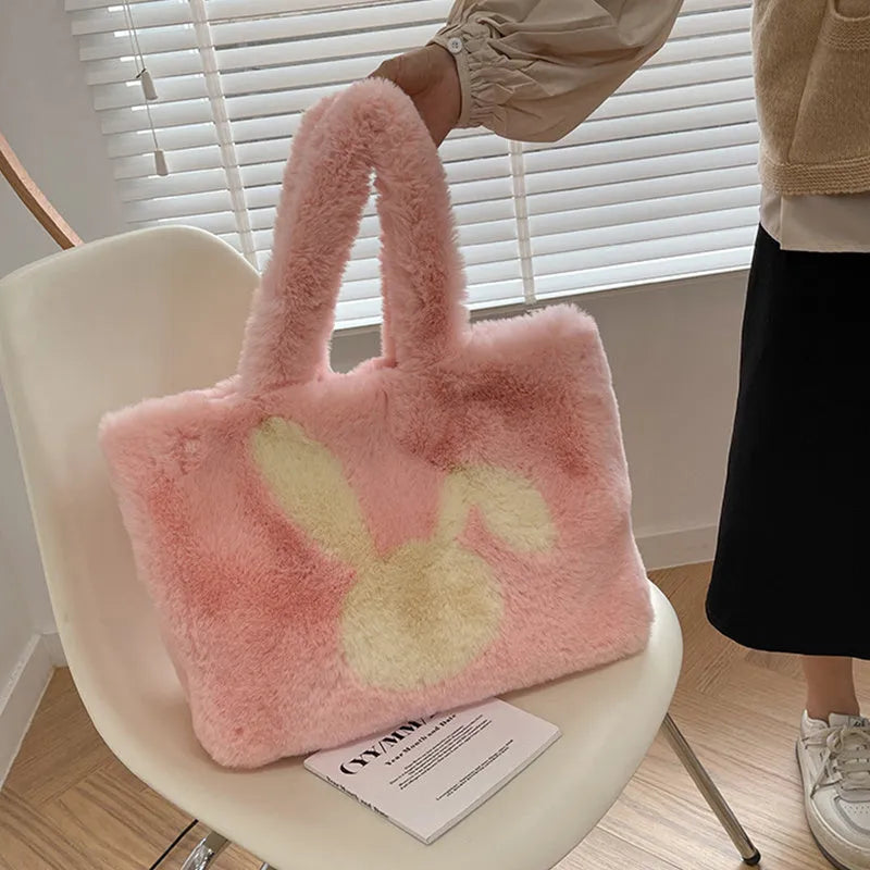 Cute cartoon rabbit ears plush shoulder tote bag in a solid colour.