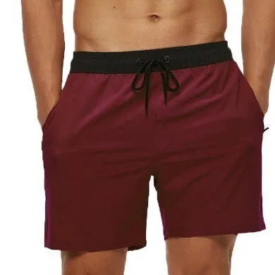 Men's blue athletic shorts with a stitching waistband, drawstring, and side headband pocket.