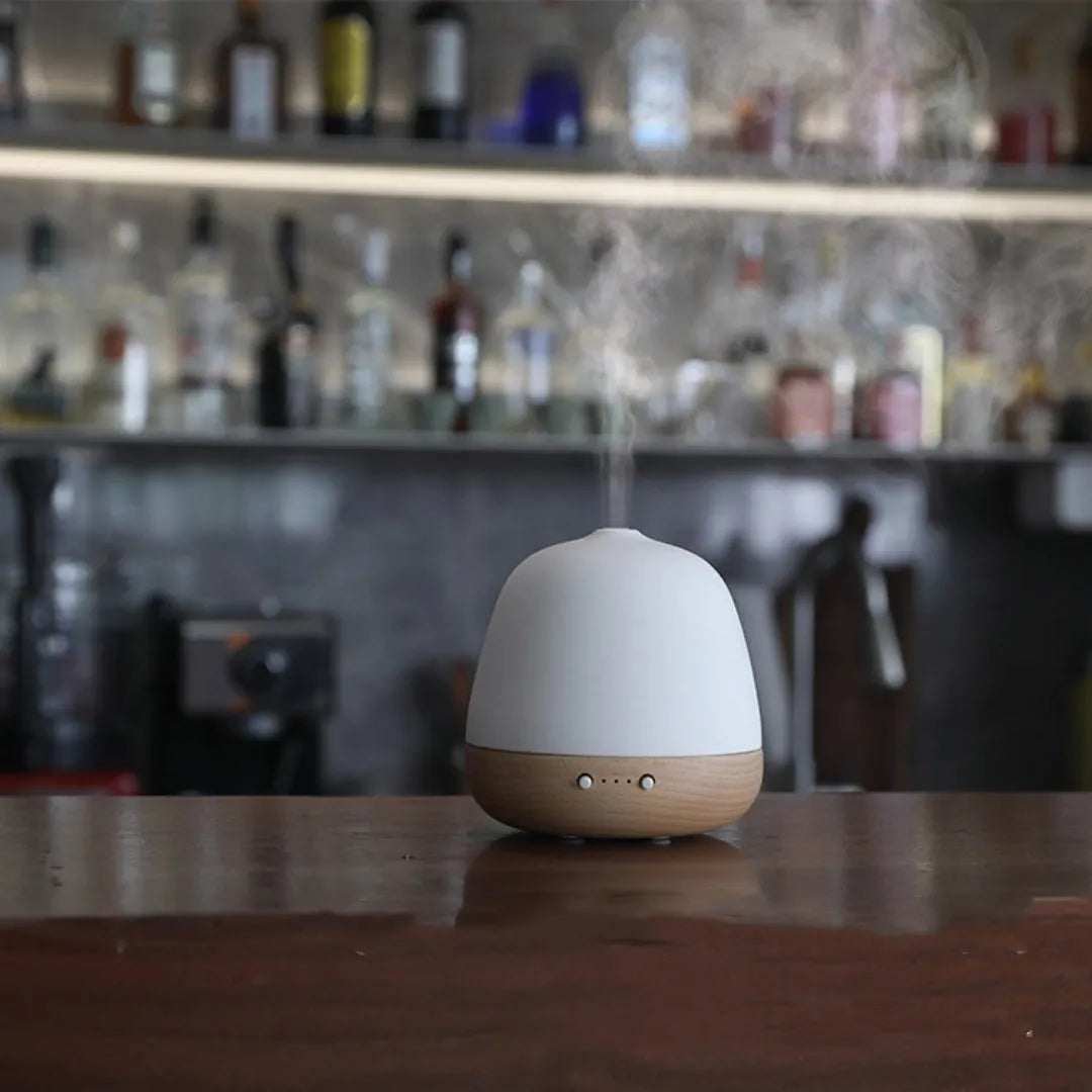 White ceramic ultrasonic essential oil humidifier with 180ml capacity on a table top