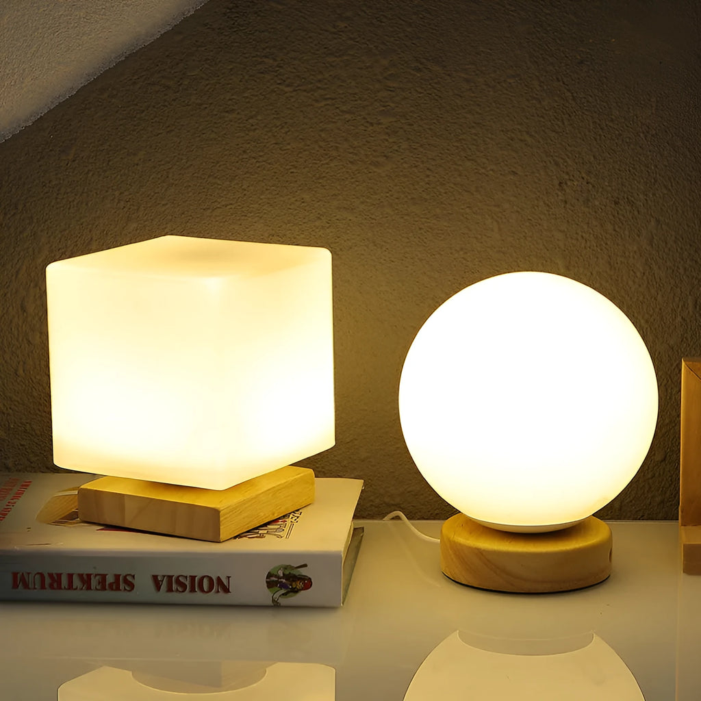 Nordic solid wood base USB table lamp with a white geometric shade on a wooden table.