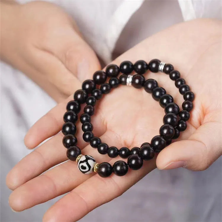 Ebony wood bracelet with 8mm beads showing two circles pattern, unisex design