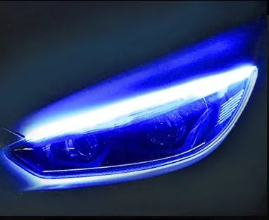 Flexible silicone car LED daytime running light strip with flowing turn signal functionality mounted on vehicle headlight