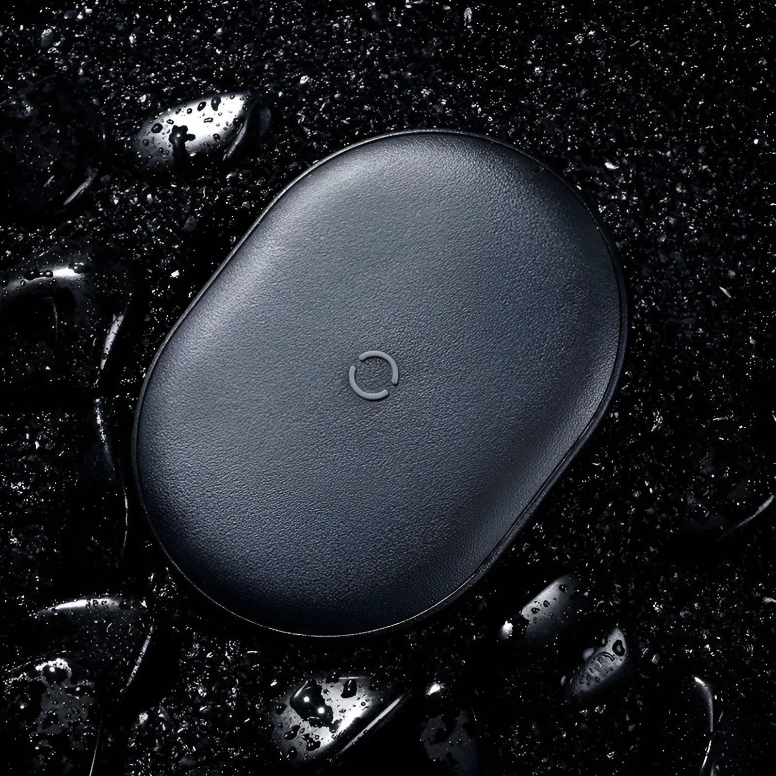 Black wireless charging pad with textured surface and indicator light for mobile phones