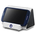 Compact black and white wireless Bluetooth mini speaker with charging cable.