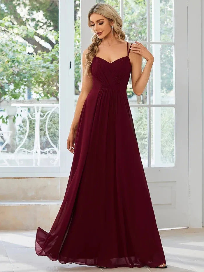 Women's light green sleeveless banquet dress with pleated A-line long skirt on a mannequin.