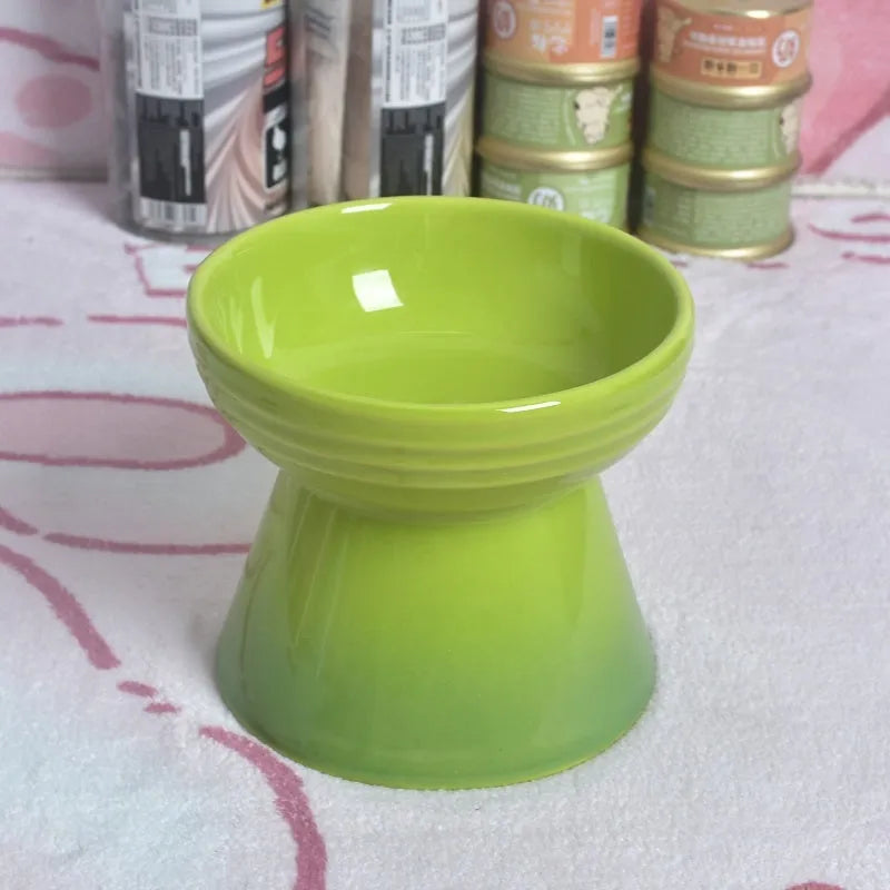 Black chin-high foot ceramic pet bowl for dogs and cats on a flat surface.