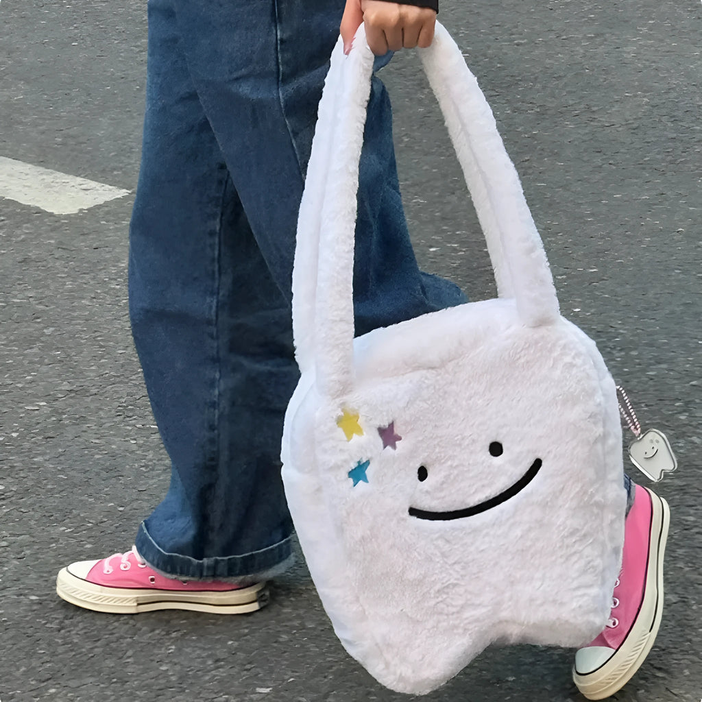 White plush shoulder tote bag with a large capacity and playful cute teeth design, shown with a crossbody strap.