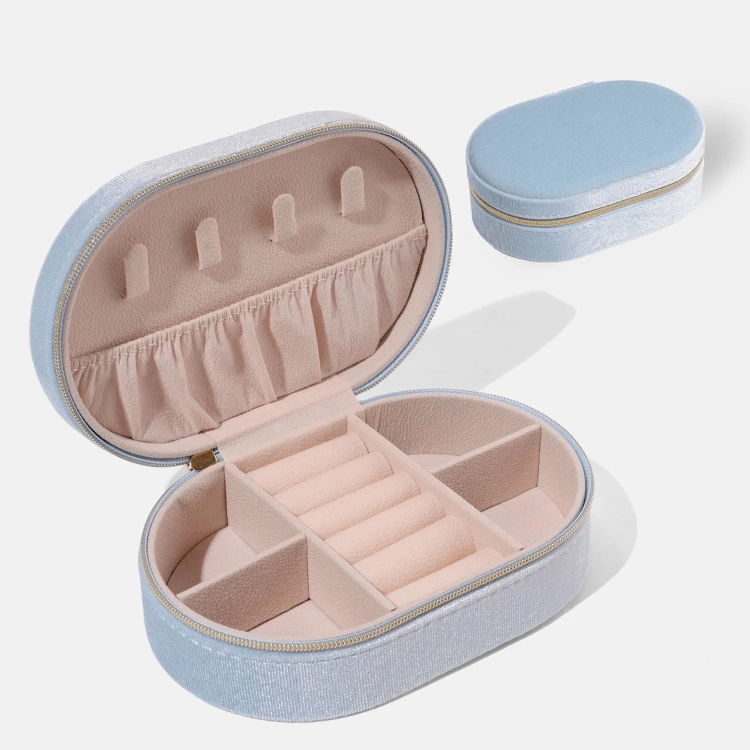 Oval shaped velvet jewellery storage box in multiple colours with flannel interior, measuring 15 by 10 by 5 cm.
