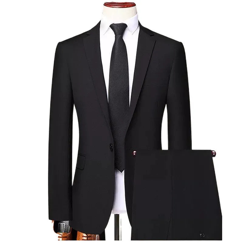 Men's slim fit three-piece suit set in black, including jacket, trousers, and tie on a hanger.