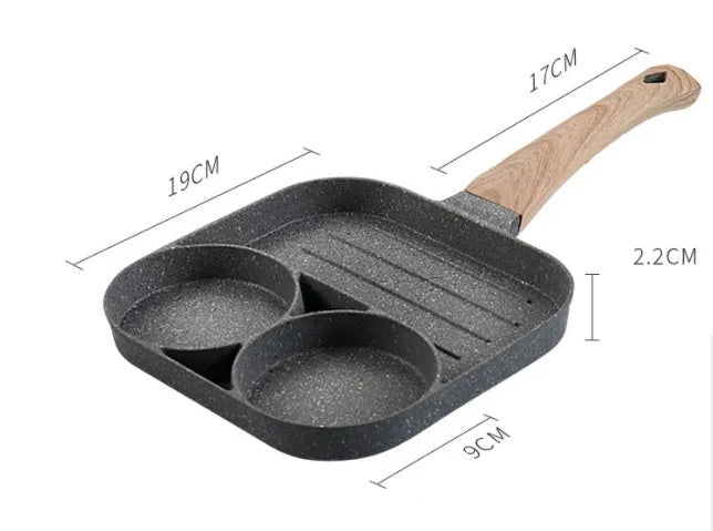 Non-stick four-hole frying pan with medical stone coating on a gas hob cooking eggs and pancakes