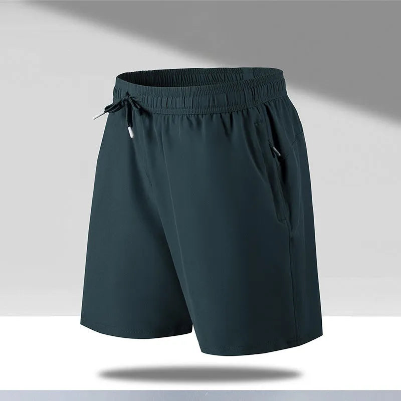 Man wearing loose-fit black quick-drying ice silk polyester sports shorts on a beach.