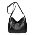 Genuine leather horizontal square messenger bag in black with contrast stitching and a front slit pocket.