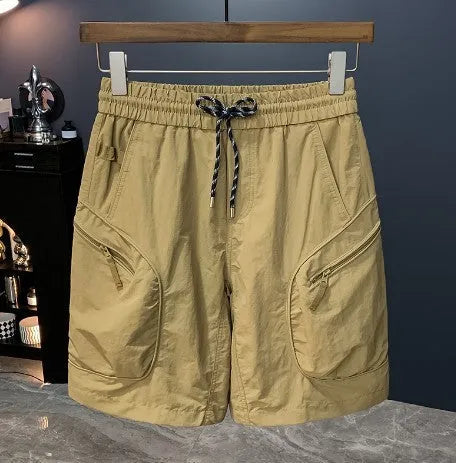 Man wearing loose-fit camouflage cargo shorts with multiple pockets, made from a cotton blend fabric.