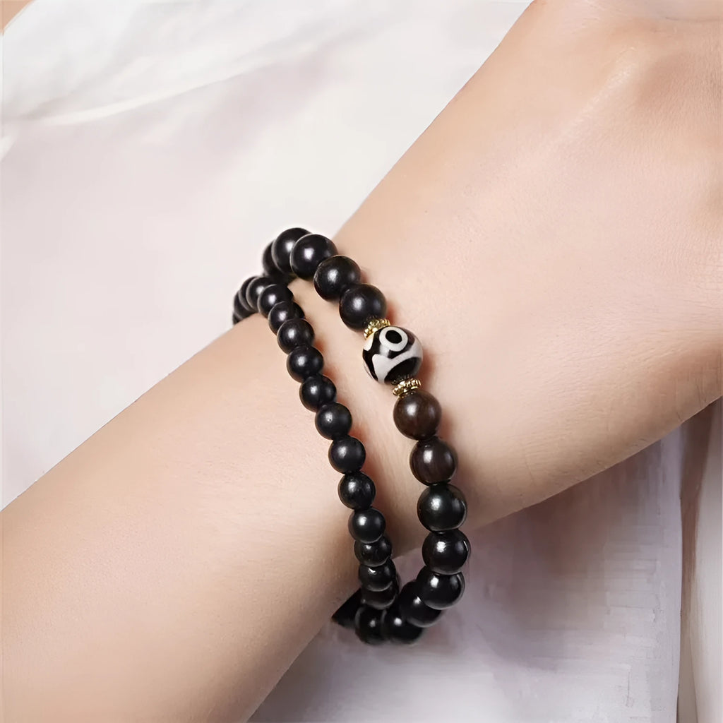 Ebony wood bracelet with 8mm beads showing two circles pattern, unisex design