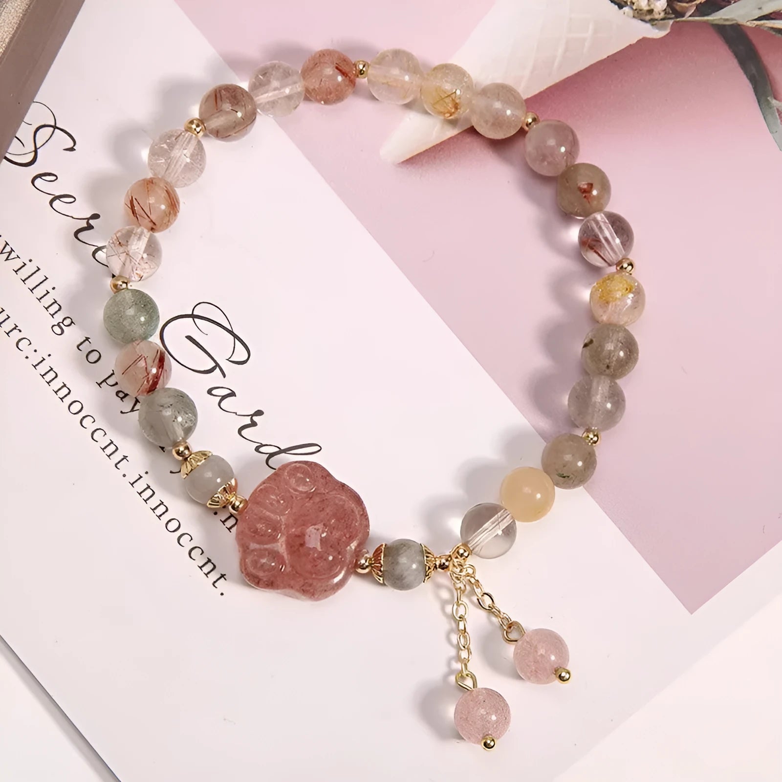 Colourful hair crystal bracelet with cat's paw, flower, butterfly, and coin purse charms on an adjustable band.