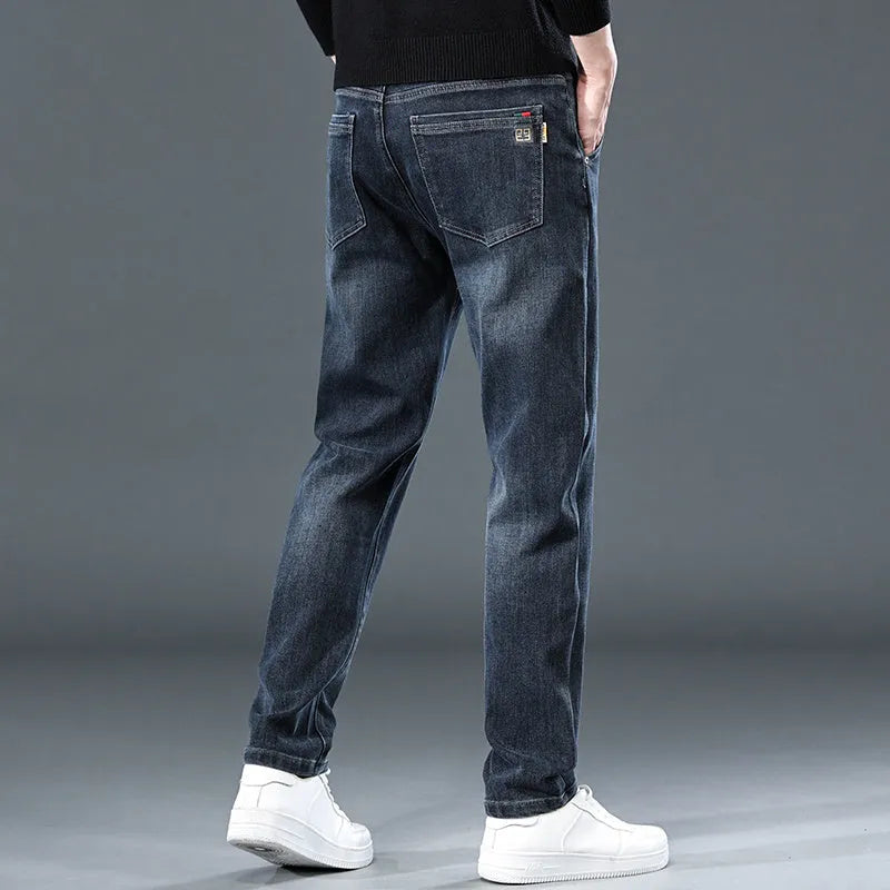 Blue gray slim straight casual men's trousers on a hanger, showing mid-waist fit and zipper fly.