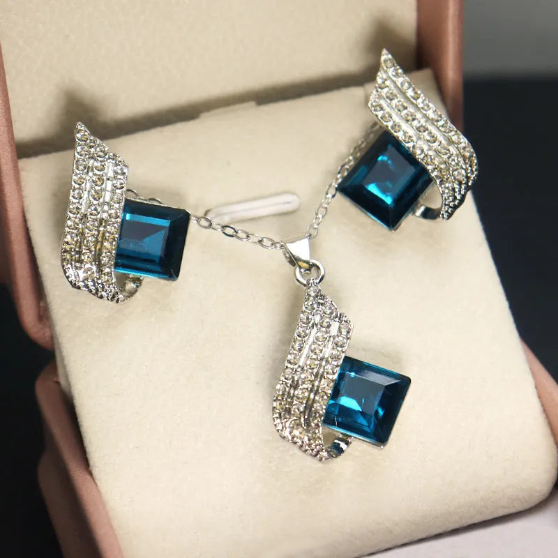 Glass and alloy necklace and earring set with cross chain styling and electroplated ornament details