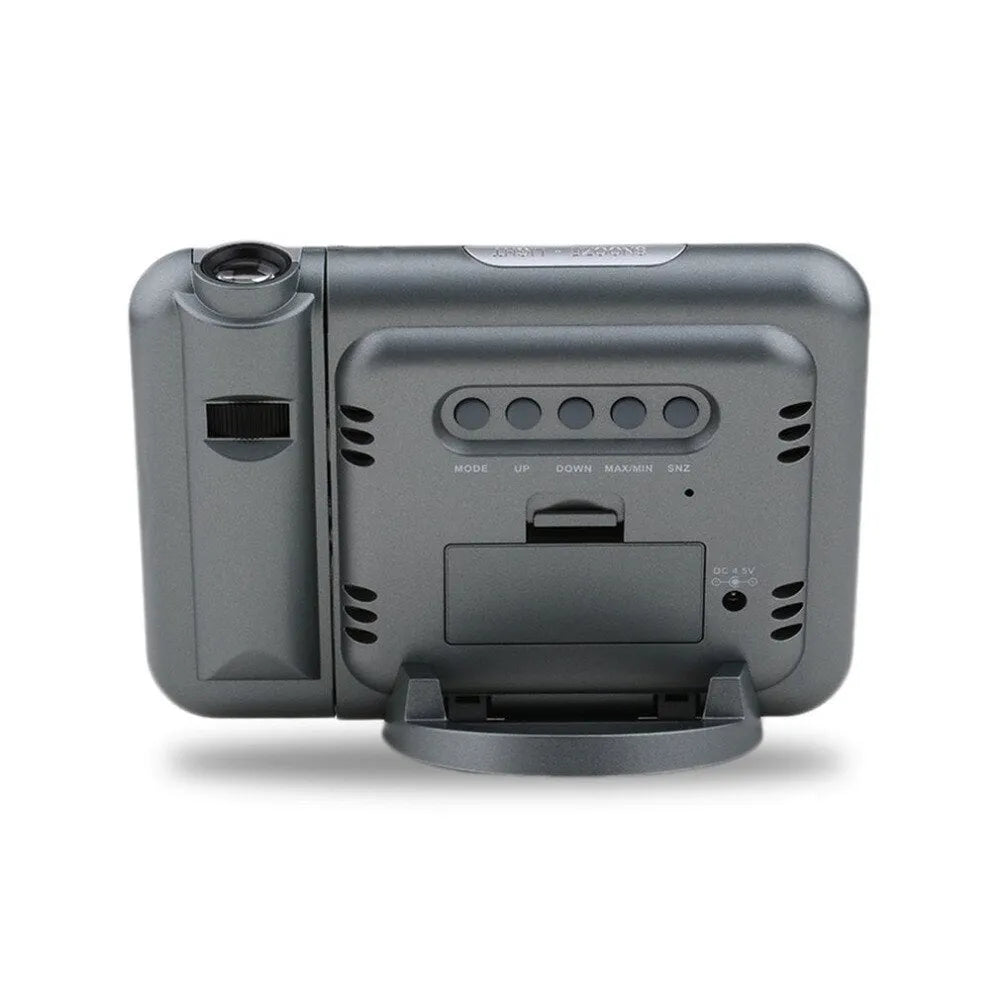 Black digital projection alarm clock with LED display showing temperature and humidity readings