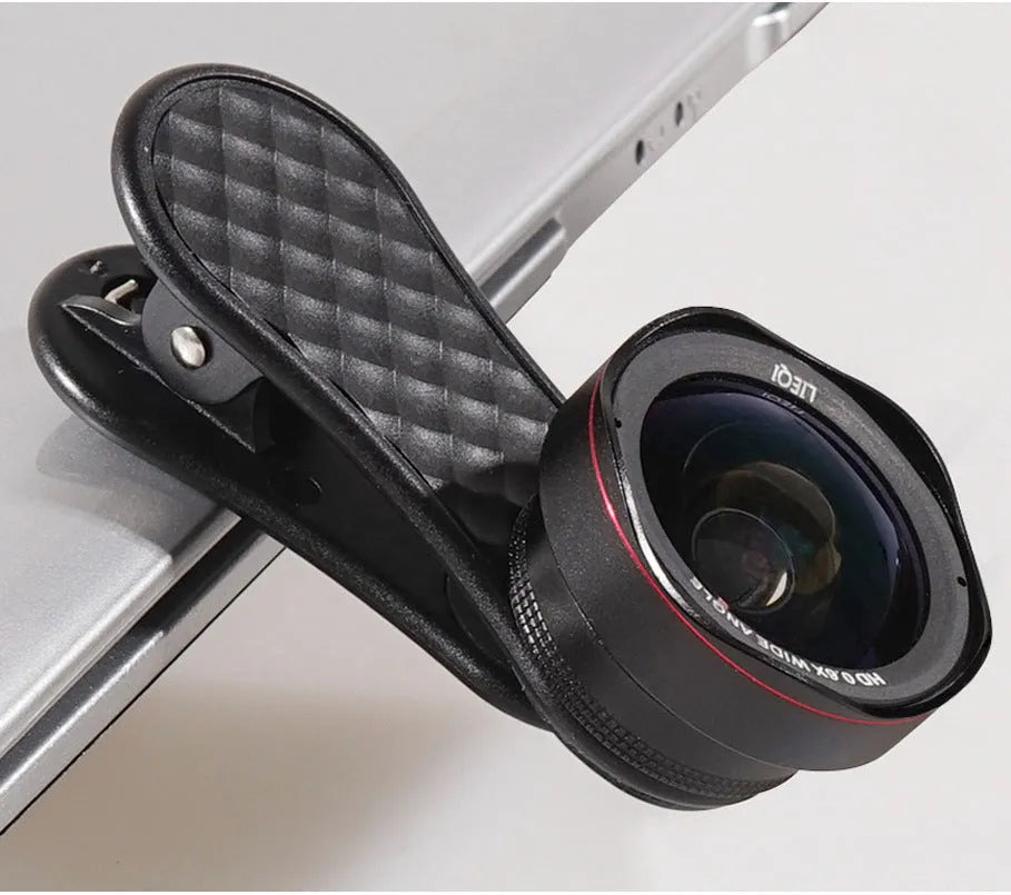 Black mobile phone wide-angle and macro external lens kit with clip and storage case on a table.