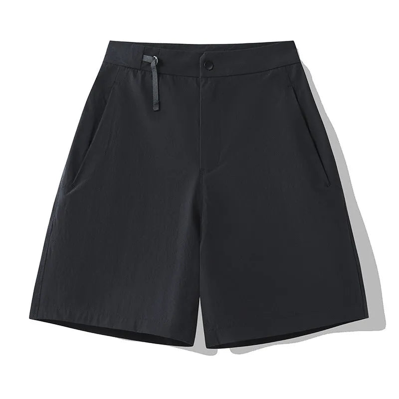 Men's solid colour quick-dry sports shorts with elastic sides on a neutral background.