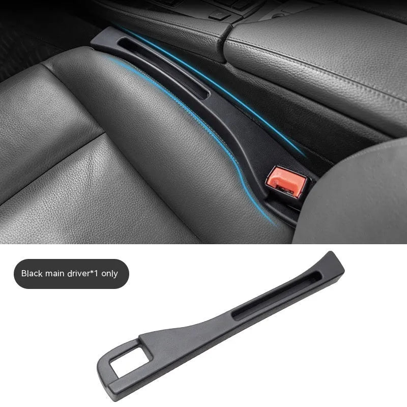 Black plastic car seat gap storage organiser box with handle inserted between car seat and centre console.