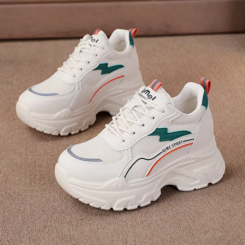 Women's white and beige height increasing dad shoes with cross straps and rubber sole.