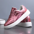 Gold sequinned platform sneakers with a round toe and a thick MD sole.