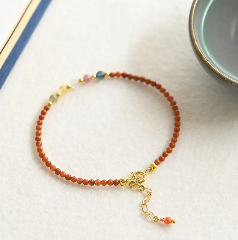Women's freshwater pearl and geometric crystal bracelet on a stretchy elastic rope.