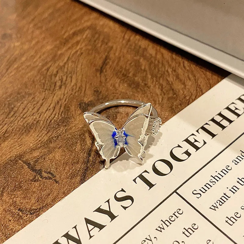 Copper butterfly women's ring with oil-drip finish showing open-loop design