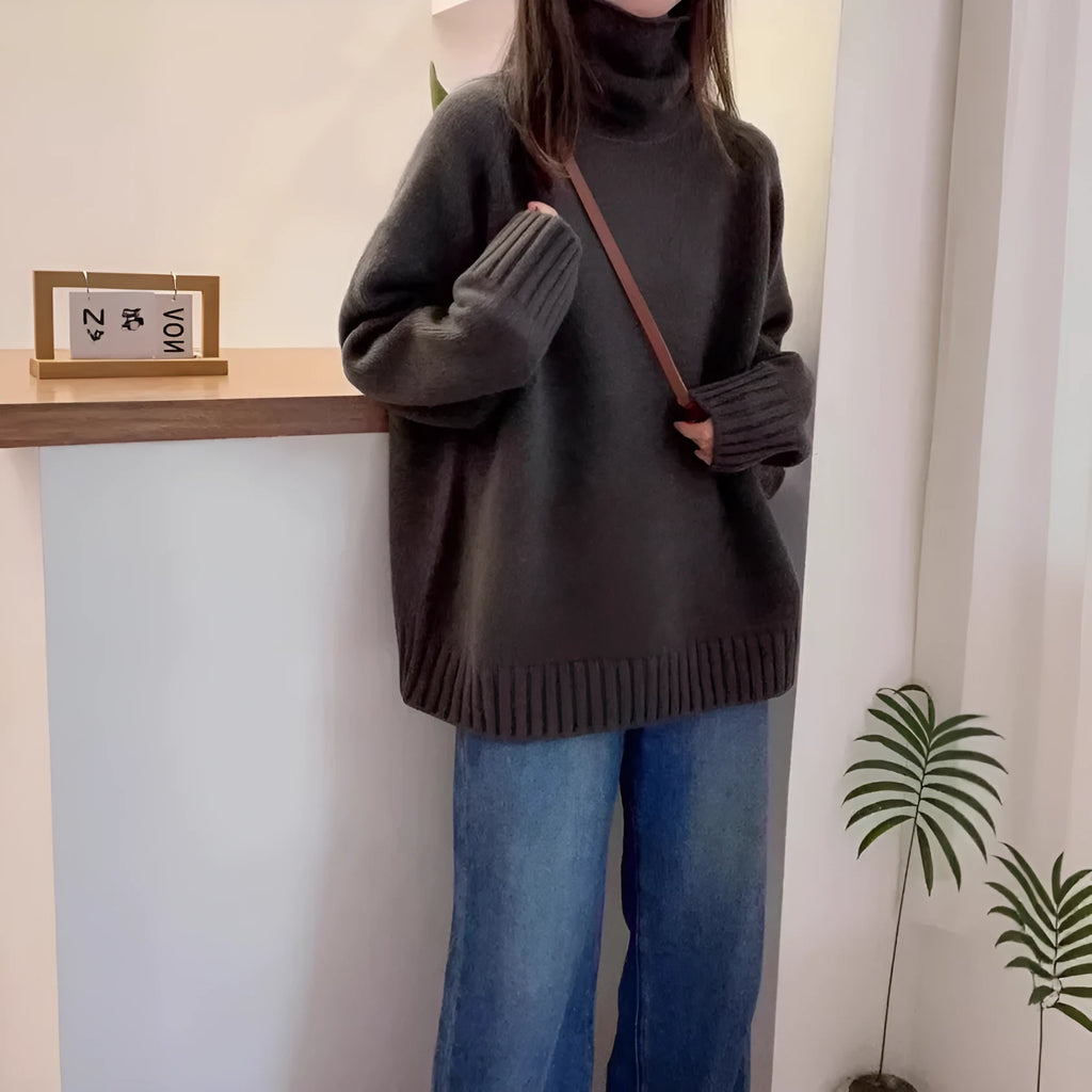 Women's thick loose turtleneck sweater in black with curling pile collar and 3D pattern