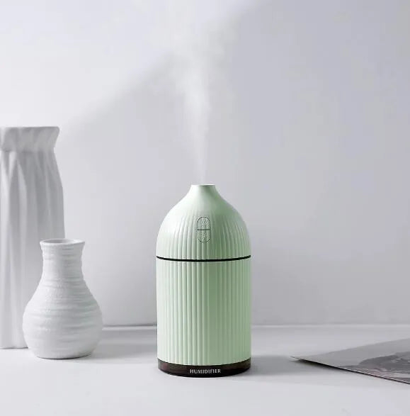 White ultrasonic essential oil diffuser and humidifier with LED light, 300ml capacity, USB cable.