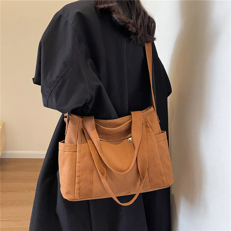 Women's polyester canvas shoulder bag with sandwich pocket in black, white, brown, or green
