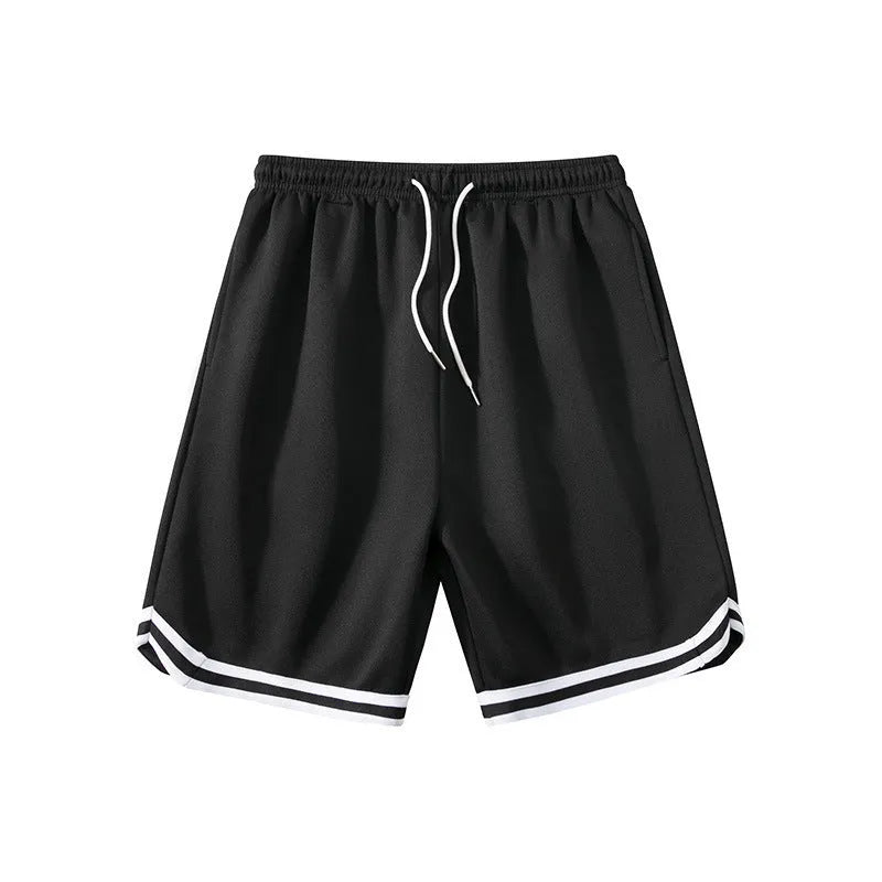 Man wearing loose fit grey polyester sports shorts on a summer day.