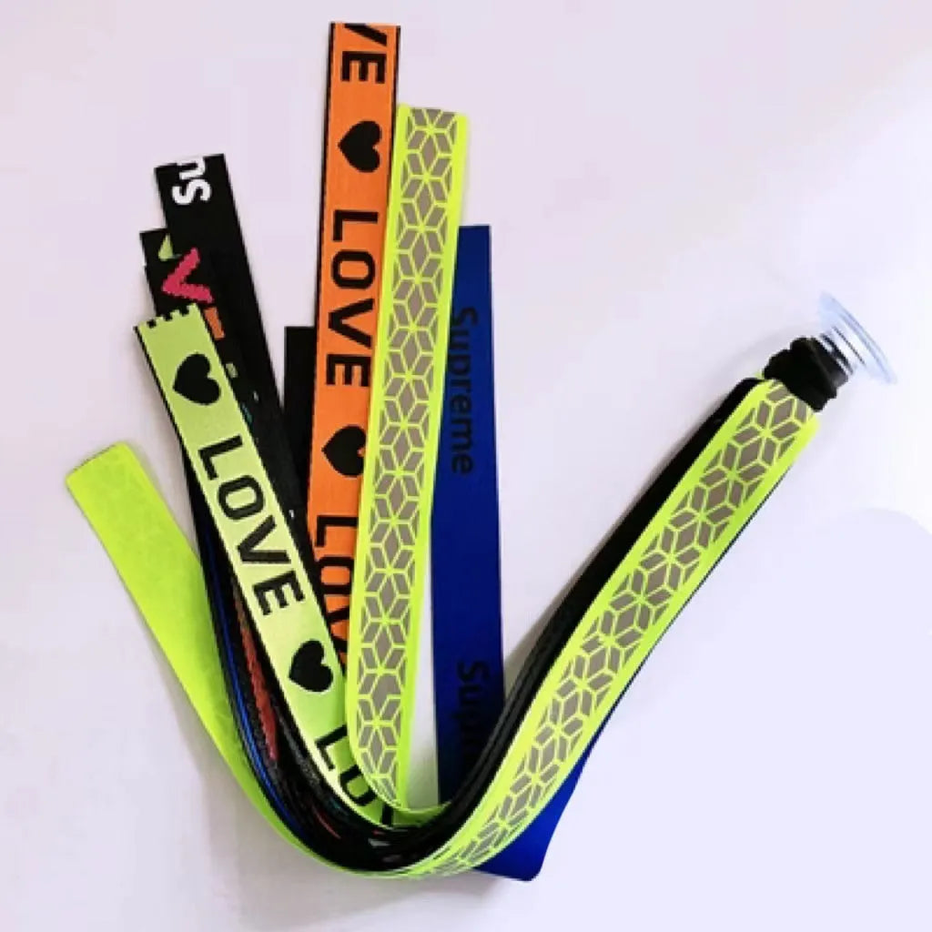Colourful fabric helmet streamers for children's roller skating and ski helmets, shown in apricot, red, and grey.