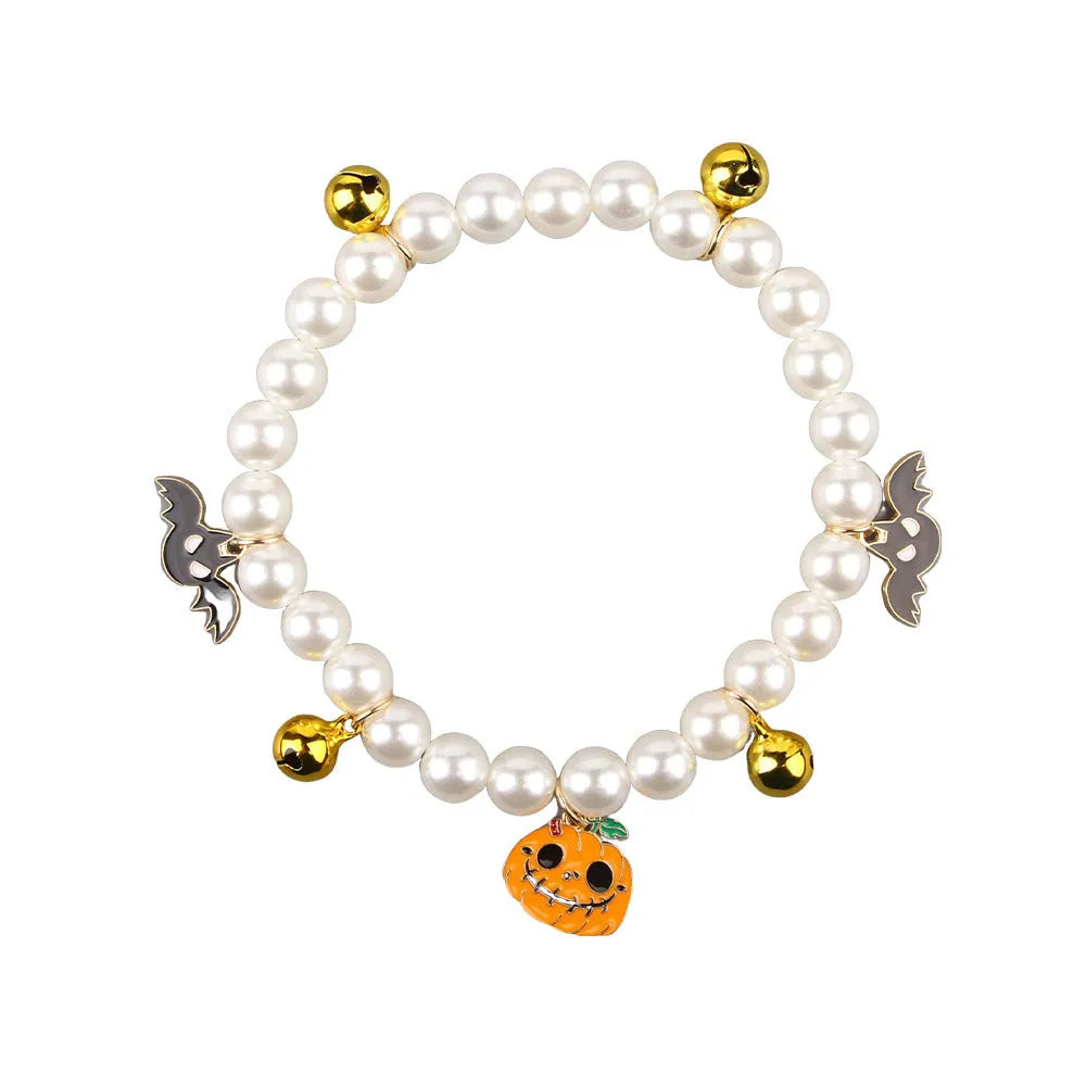 Halloween cat collar with simulated pearl decoration showing purple ghost, skull pumpkin, and smiling pumpkin design options