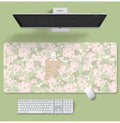Large floral pattern mouse pad on a desk with keyboard and mouse, showing non-slip rubber base.