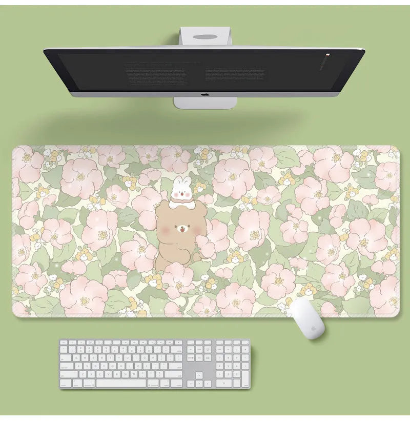 Large floral pattern mouse pad on a desk with keyboard and mouse, showing non-slip rubber base.