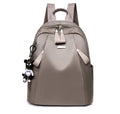 Medium-sized grey Oxford cloth rucksack with double straps, shown open to reveal internal phone and ID pockets.