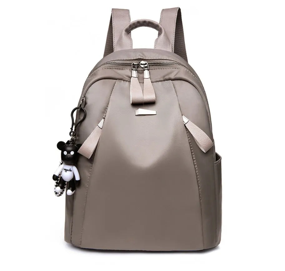 Medium-sized grey Oxford cloth rucksack with double straps, shown open to reveal internal phone and ID pockets.