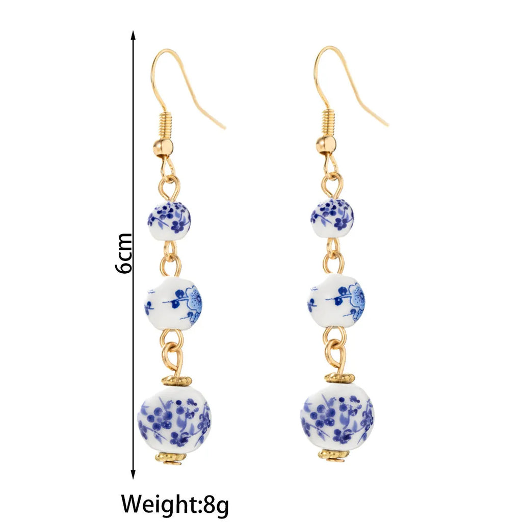 Blue and white porcelain ceramic bead long drop earrings with geometric alloy design