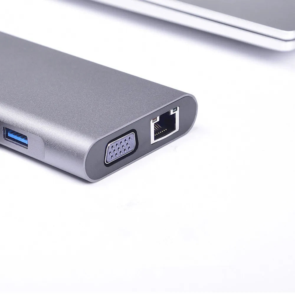 Silver 10-in-1 USB-C docking hub for MacBook with multiple ports including HDMI, USB, and SD card slots.