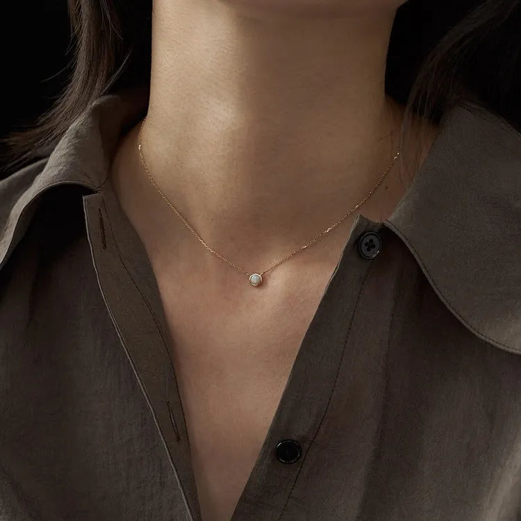 Geometric oval jelly opal pendant necklace on a chain in gold or silver tone.