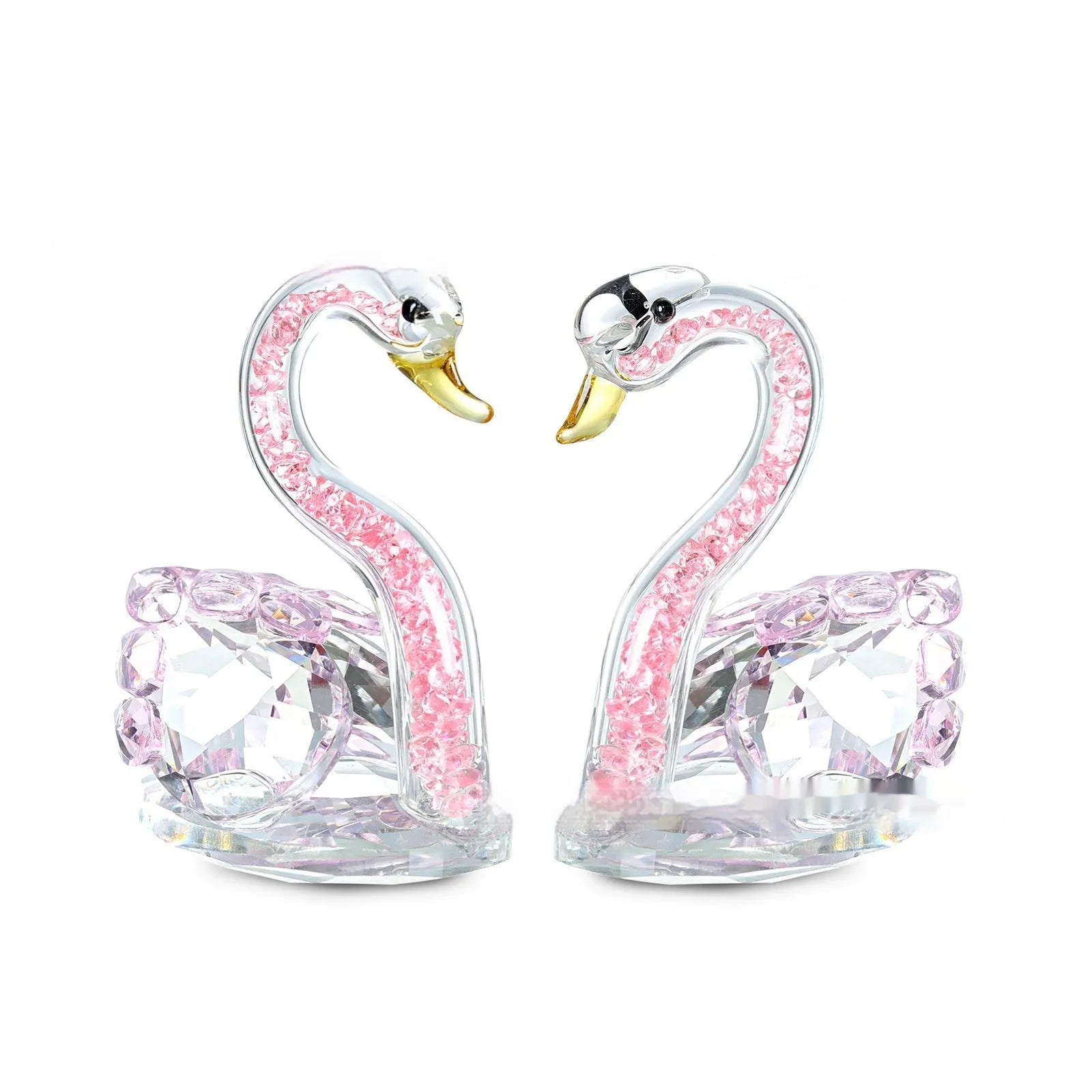 White crystal swan decoration on a desktop in solid head and empty tube styles.