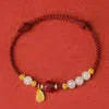 Hetian jade and cinnabar red rope women's bracelet with adjustable sterling silver chain.