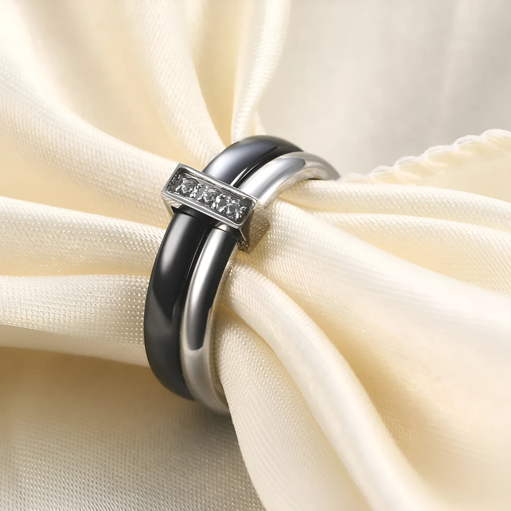 Steel black ceramic women's ring with glossy stitching and zirconium accents, geometric shape.